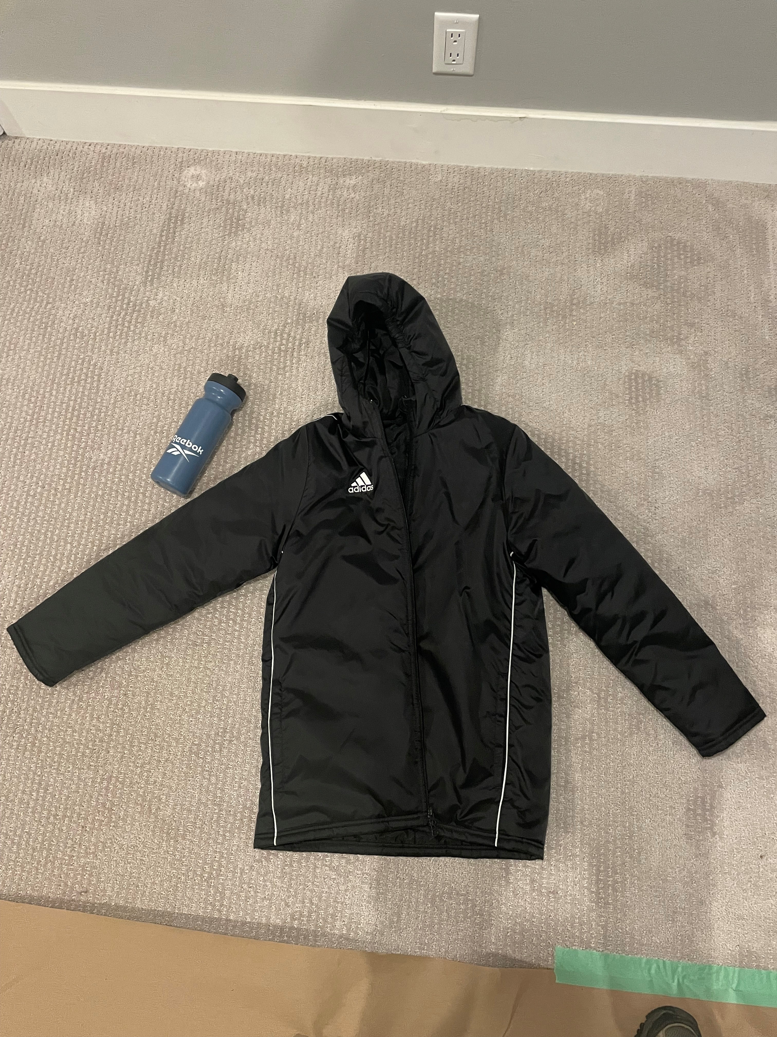Black Adidas hooded jacket & blue Reebok water bottle